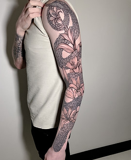 Serpent and lily sleeve tattoo by Inshaan at Black Canvas